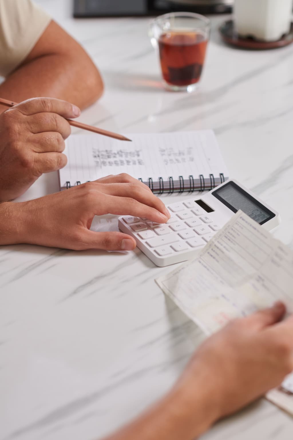 Hoteliers calculating costs for their hotel manually