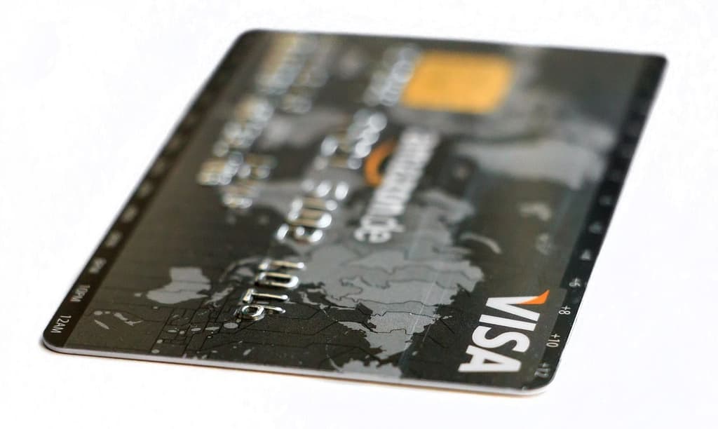 Plastic visa credit card with a world map