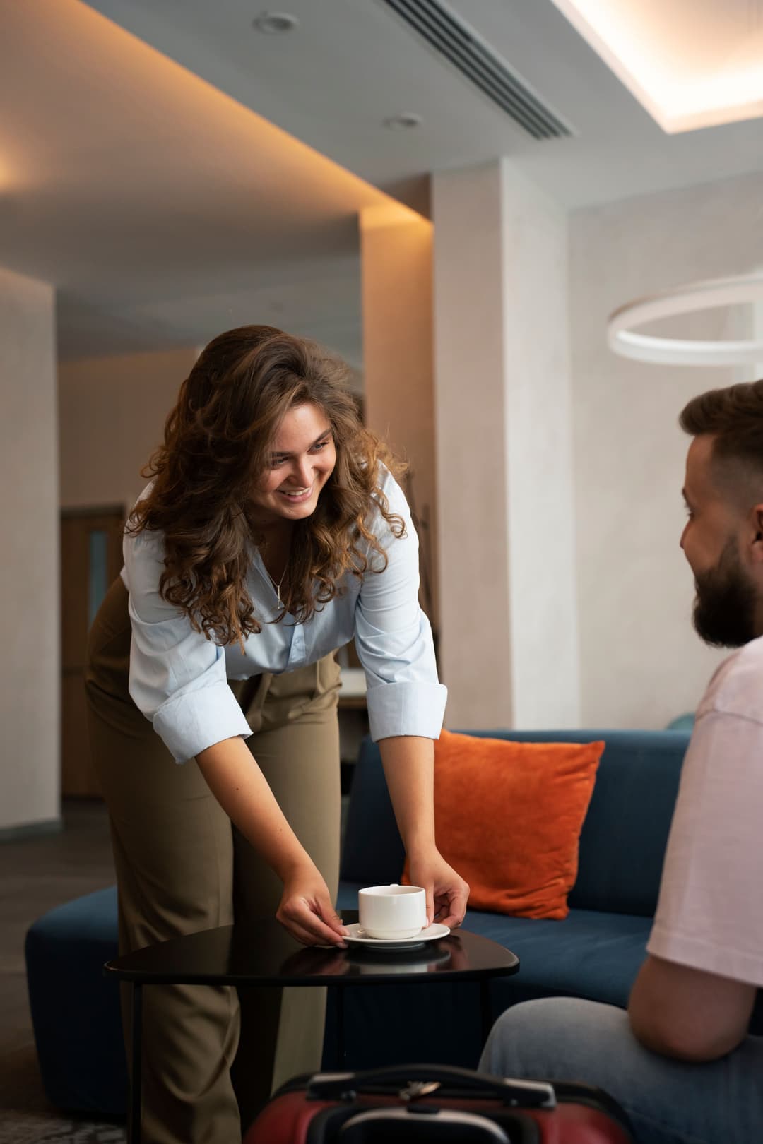 Hotelier serving coffee to a guest