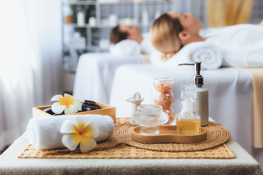 a couple in a hotel spa with aromatherapy items in a nearby table